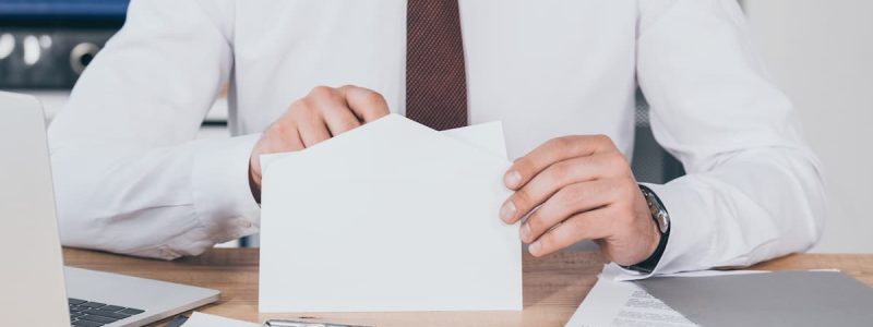 cropped-view-of-businessman-opening-envelope-in-of-2022-11-02-02-10-02-utc (1)