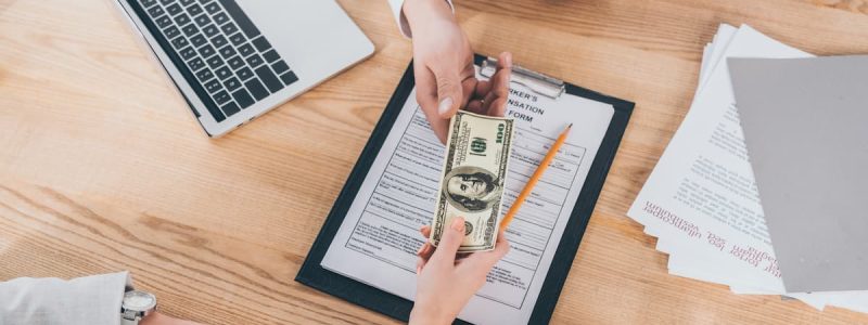 partial-view-of-businesswoman-giving-money-to-busi-2022-11-02-03-36-39-utc (1)